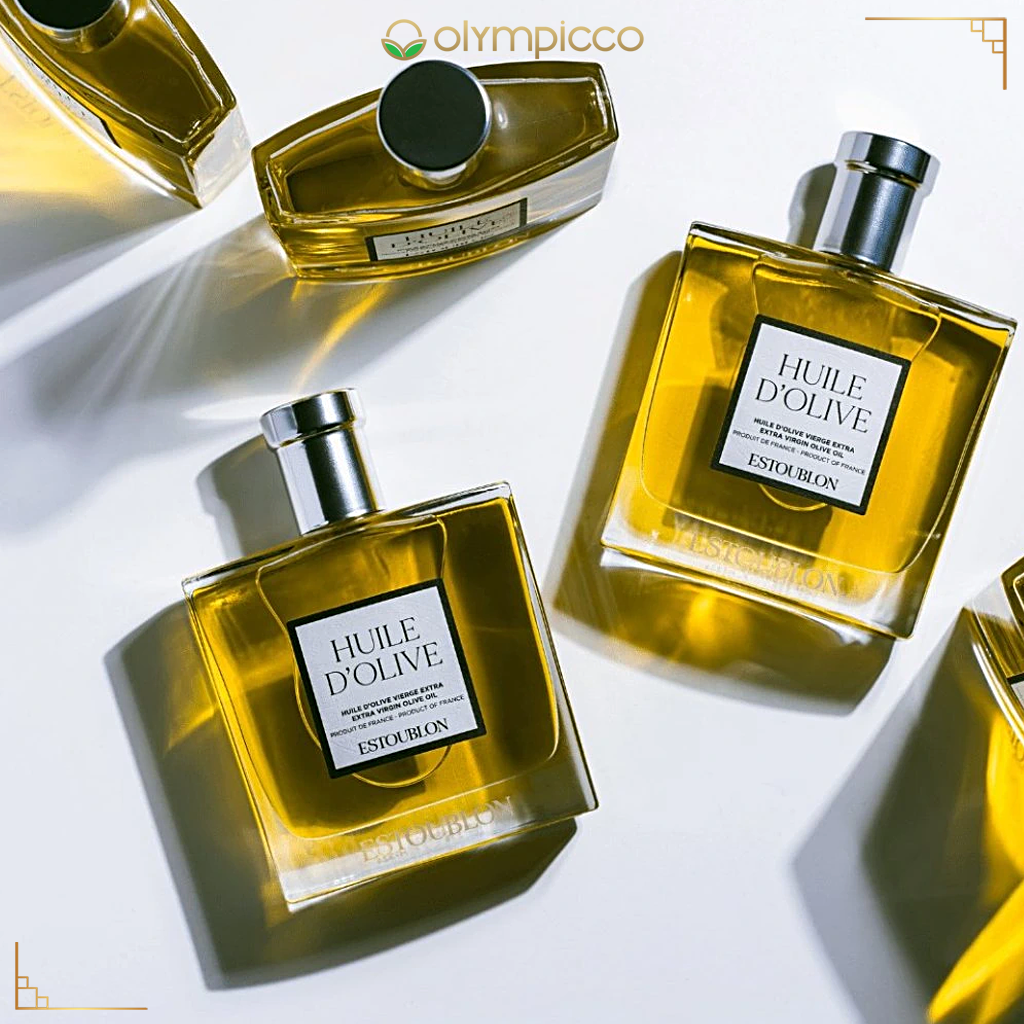 Estée Lauder Huile d'Olive perfume bottles on a white background with Olympicco branding.